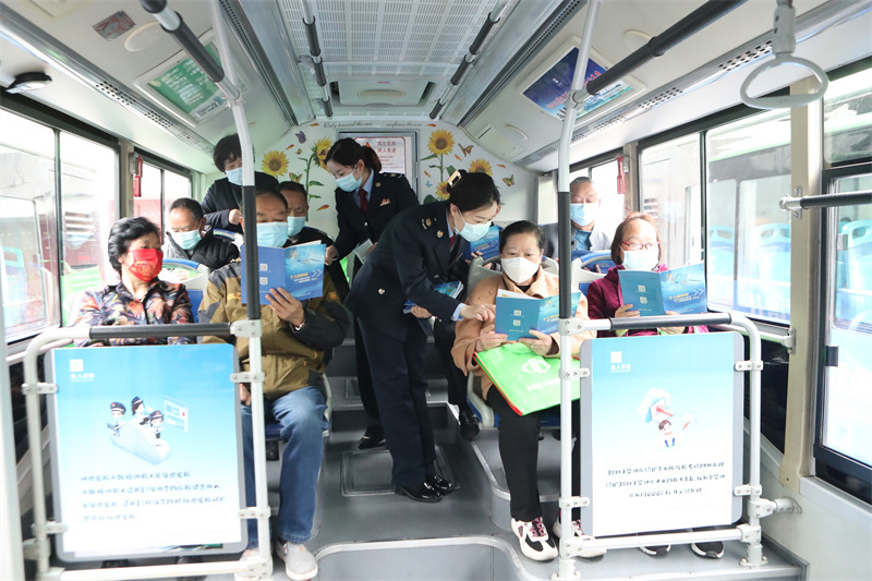税务干部在公交车上宣传组合式税费支持政策.JPG